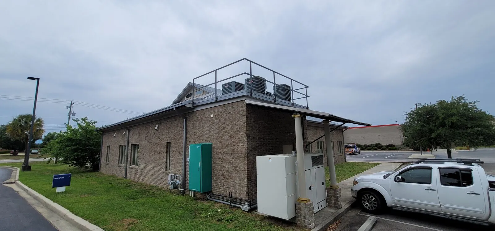 Rear view of a commercial bank building with rooftop mechanical screening