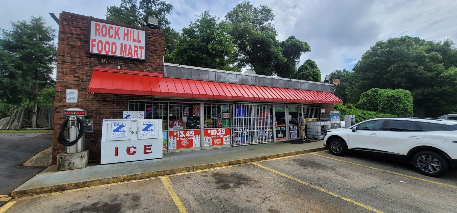 Renovated convenience store exterior with new red awning at Rock Hill Food Mart