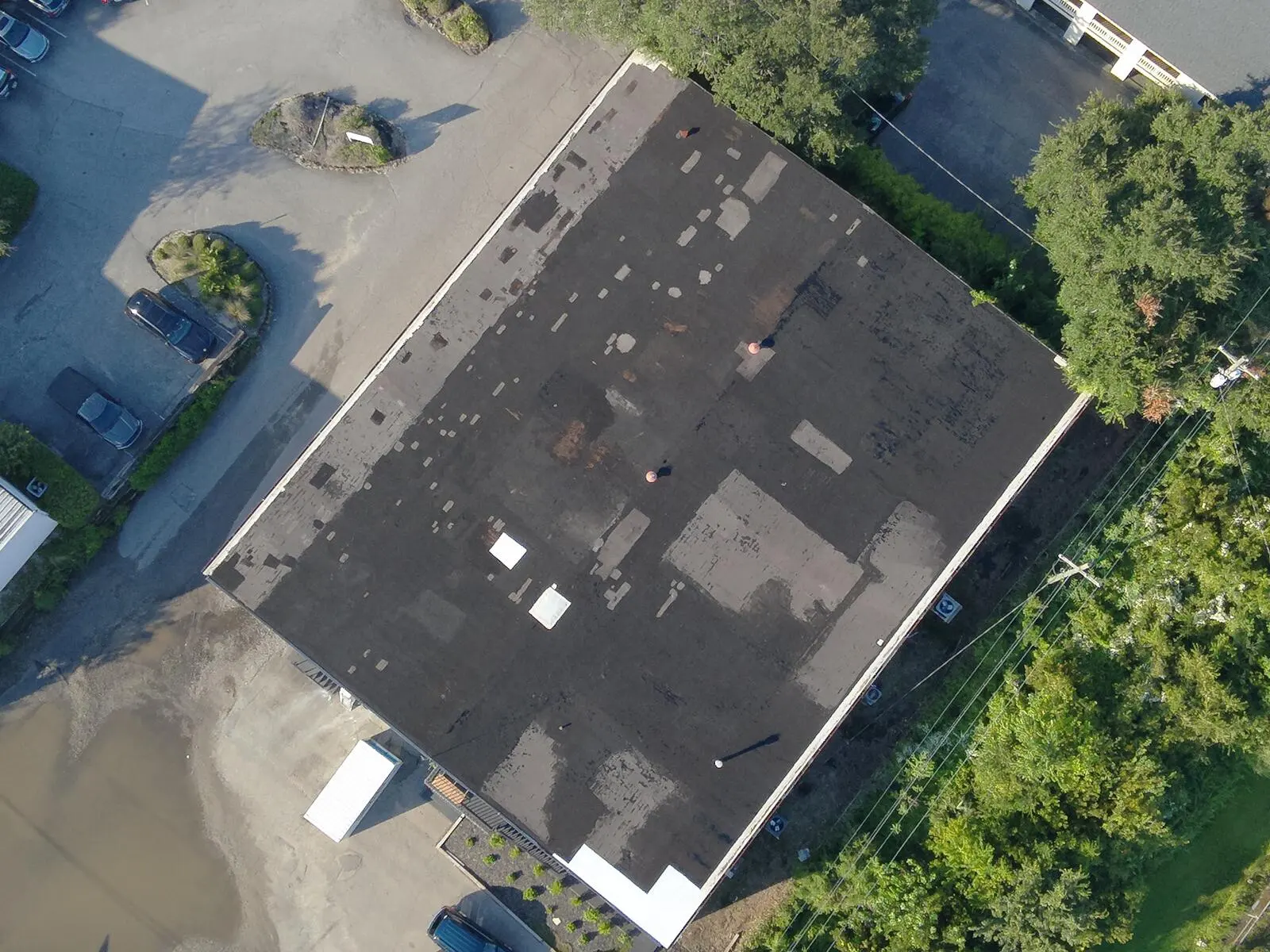Aerial view of a large commercial flat roof surveyed before restoration